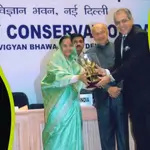 Group of people receiving a trophy during an award ceremony on stage