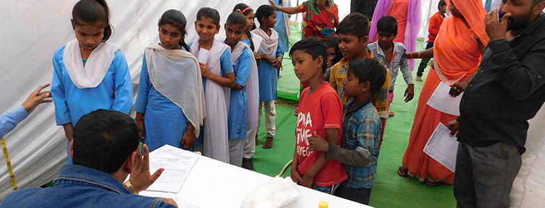 School children attending free health checkup camp organized by Prism Cement