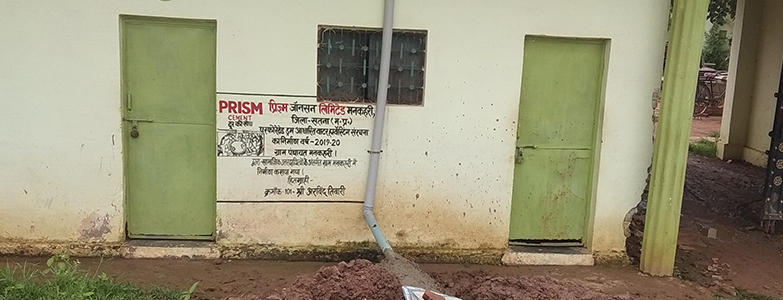 Prism building with green doors and drainage pipe