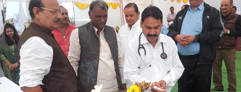 Doctor and local officials lighting lamp during inauguration program