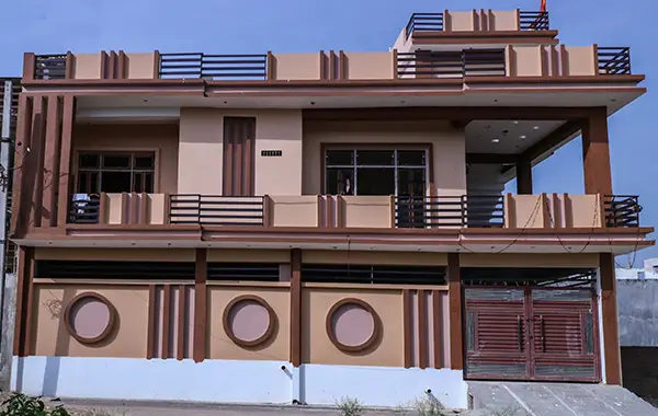 Front view of a modern two-storey Indian house with balcony and stylish exterior