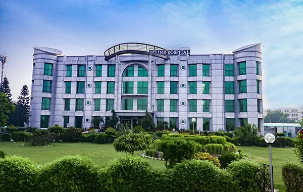 Front view of hospital with glass windows and landscaped garden