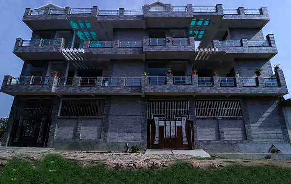 Modern three-storey residential building with spacious balconies and contemporary design