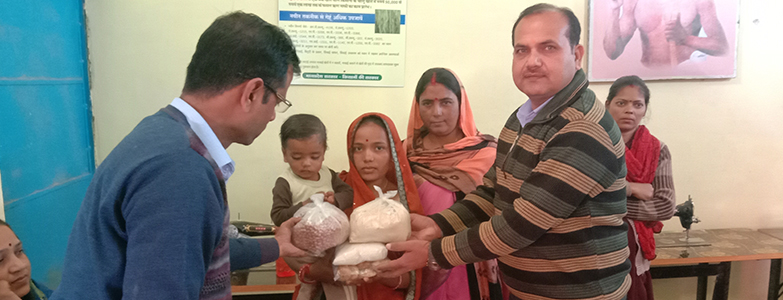 Health workers distributing nutritional food packages to rural women