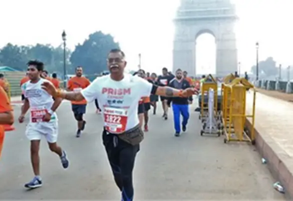 Prism Johnson employee participating in a marathon near India Gate during a corporate fitness event