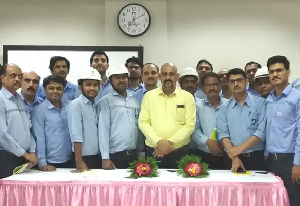 Prism Johnson employees and trainers posing for a group photo during an indoor training