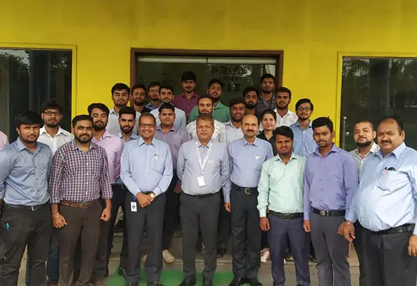 Prism Johnson employees attending a training and development session, posing for a group photo outside the office