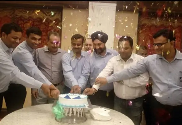 Employees at Prism Johnson celebrating together with a cake-cutting event