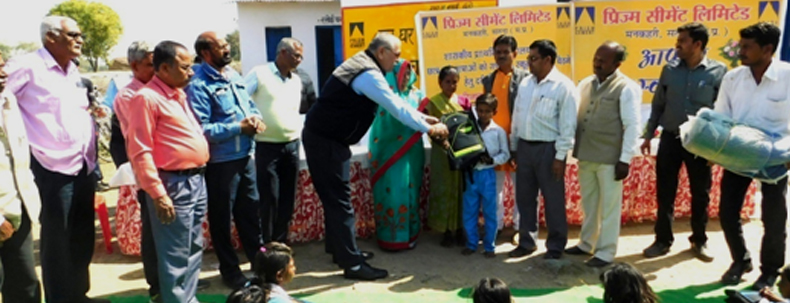 Officials handing over school supplies to children during a donation event for education support.