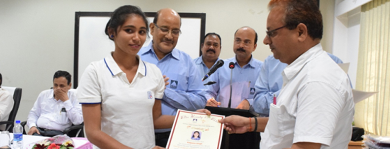 Young woman receiving certificate during skill development training program ceremony