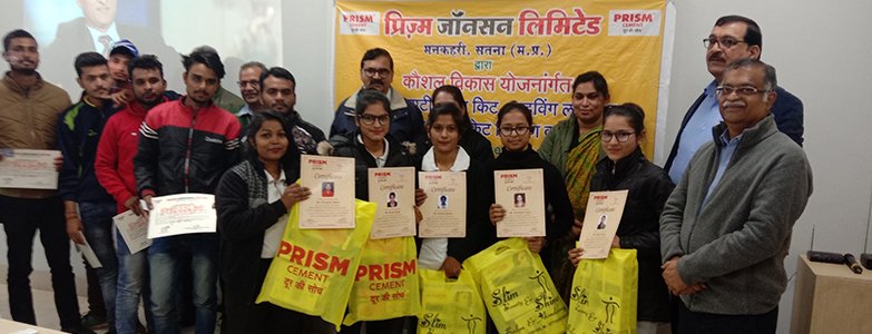 Youth receiving certificates and training kits during a skill development program