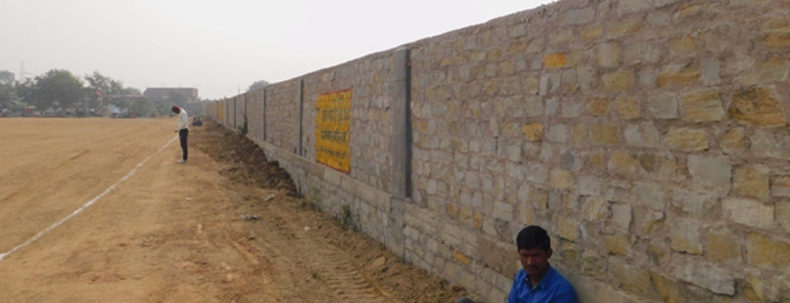 Construction of boundary wall around sports ground