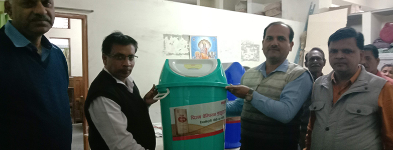 Officials distributing dustbins under Swachh Bharat cleanliness drive to promote waste management and hygiene awareness