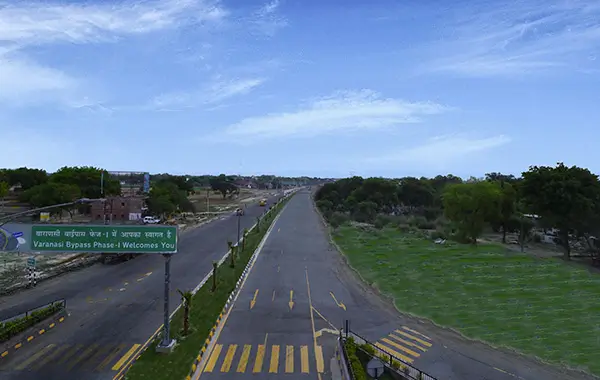 Varanasi Bypass Phase 1 highway road with welcome signboard and greenery under clear blue sky