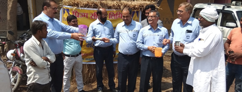Officials distributing water to villagers during a community outreach program