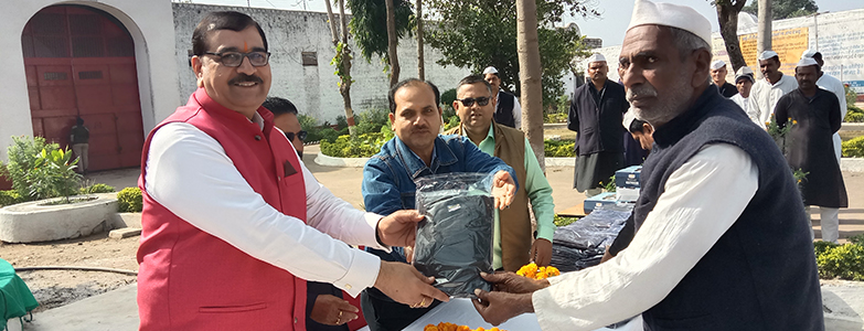 Prism Cement team distributing winter clothes to local community members